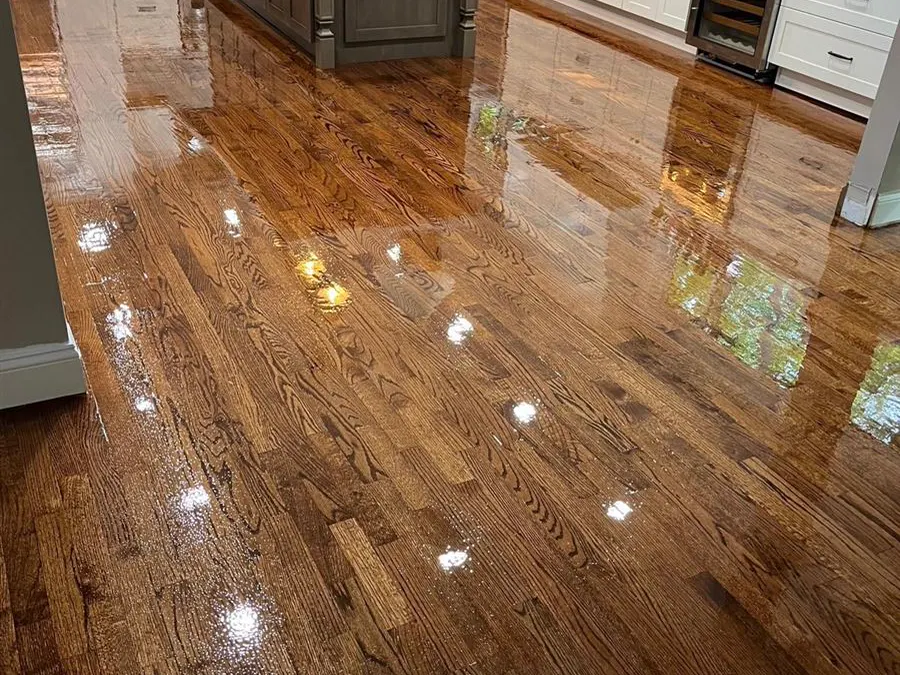 Oak floor with a gloss finish in a kitchen with white cabinets